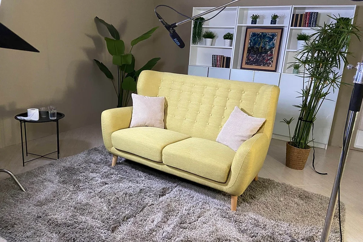 A yellow sofa and microphone prepared for a Data.org interview